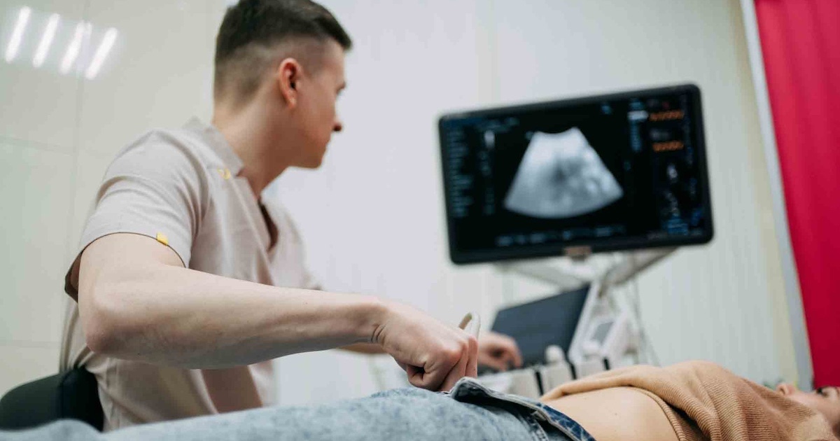 Technician performing an ultrasound Technician performing an ultrasound