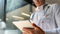 Healthcare provider looking at a tablet Healthcare provider looking at a tablet