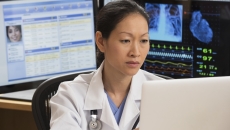 Healthcare technician reviewing MRI data Healthcare technician reviewing MRI data