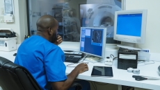 Healthcare professional looking at MRI data Healthcare professional looking at MRI data