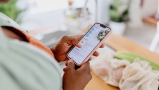Person looking at a health app on their phone Person looking at a health app on their phone