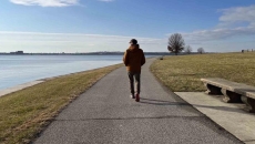 Person walking near an ocean Person walking near an ocean