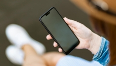 Person holding a smartphone Person holding a smartphone