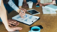 Photo of people reviewing data/charts/graphs Photo of people reviewing data/charts/graphs