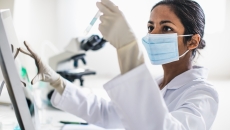 Technician analyzing the content of a test tube Technician analyzing the content of a test tube