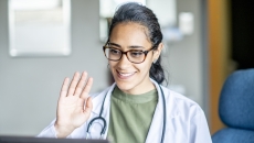 Healthcare professional engaging remotely via a laptop computer Healthcare professional engaging remotely via a laptop computer