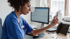 Healthcare professionals interacting with a person on a cell phone Healthcare professionals interacting with a person on a cell phone