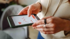 A person looking at data on a smart phone A person looking at data on a smart phone