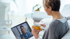 Woman interacting with healthcare professional via laptop  Woman interacting with healthcare professional via laptop