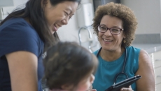 A woman and child talking to a healthcare professional A woman and child talking to a healthcare professional
