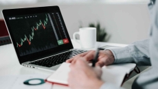 Young businessman using laptop for analyzing data stock market Young businessman using laptop for analyzing data stock market