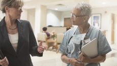Two people walking through a healthcare facility Two people walking through a healthcare facility