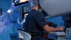 A surgeon operating using robotic technology