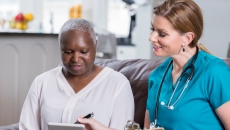 Healthcare professional and patent in an in-home visit Healthcare professional and patent in an in-home visit