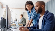 Business people looking at a desktop computer Business people looking at a desktop computer