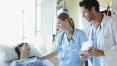 Healthcare professionals consulting with a patient Healthcare professionals consulting with a patient