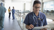 Healthcare professional looking at a tablet Healthcare professional looking at a tablet