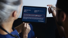 Two people reading a tablet with analysis from EchoGo Heart Failure Two people reading a tablet with analysis from EchoGo Heart Failure