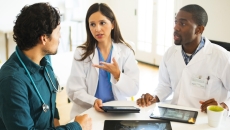 Healthcare professionals reviewing and discussing clinical data Healthcare professionals reviewing and discussing clinical data