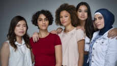 Five people standing in a group looking at the camera Five people standing in a group looking at the camera