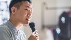 Person speaking in a microphone Person speaking in a microphone