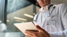 Healthcare provider holding a tablet