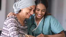 Two people sitting with one embracing the other Two people sitting with one embracing the other