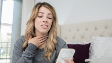 A woman participates in a telemedicine visit via smartphone A woman participates in a telemedicine visit via smartphone