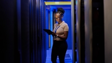 Person standing in a data center Person standing in a data center