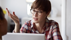 Person at a computer talking Person at a computer talking