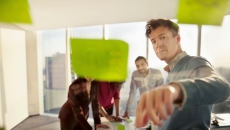 people looking at sticky notes People looking at sticky notes