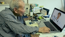 Person interacting with a healthcare professional via a telehealth visit Person interacting with a healthcare professional via a telehealth visit