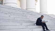 Man sitting on court building steps Man sitting on court building steps