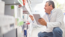 Pharmacist reviewing inventory Pharmacist reviewing inventory
