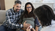 Couple, pregnant women consulting with a healthcare professional Couple, pregnant women consulting with a healthcare professional