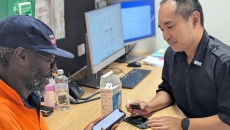 A patient with diabetes being assisted in using a mobile app to track their blood glucose level A patient with diabetes being assisted in using a mobile app to track their blood glucose level