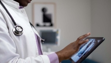 Healthcare provider looking at x-ray images on a tablet Healthcare provider looking at x-ray images on a tablet