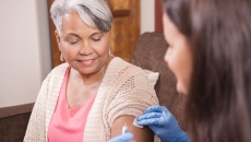 Health care professional administering an injectable medication