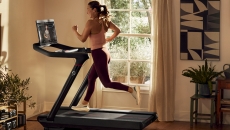 A person exercising on a Peloton treadmill A person exercising on a Peloton treadmill