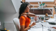 Person grabbing their shoulder due to discomfort Person grabbing their shoulder due to discomfort