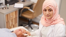 Technician performing ultrasound procedure Technician performing ultrasound procedure