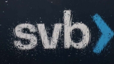 The Silicon Valley Bank (SVB) logo is seen through a rain covered window in front of the SVB headquarters. The Silicon Valley Bank (SVB) logo is seen through a rain covered window in front of the SVB headquarters.