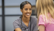 Person sitting with a school nurse Person sitting with a school nurse