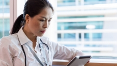 Healthcare practitioner reviewing EMR Healthcare practitioner reviewing EMR