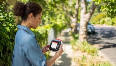 A woman holding the Avive device that is displaying a map A woman holding the Avive device that is displaying a map