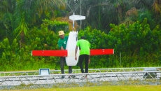 Two individuals preparing a done Two individuals preparing a done