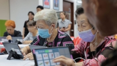 Seniors at Lions Befrienders playing the AMI app on their tablets Seniors at Lions Befrienders playing the AMI app on their tablets