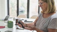 A woman checking her blood sugar. A woman checking her blood sugar.