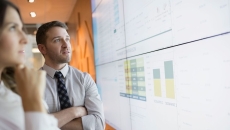 Businesspeople looking at financial charts. Businesspeople looking at financial charts.