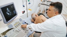 A doctor conducting a cardiac ultrasound. A doctor conducting a cardiac ultrasound.